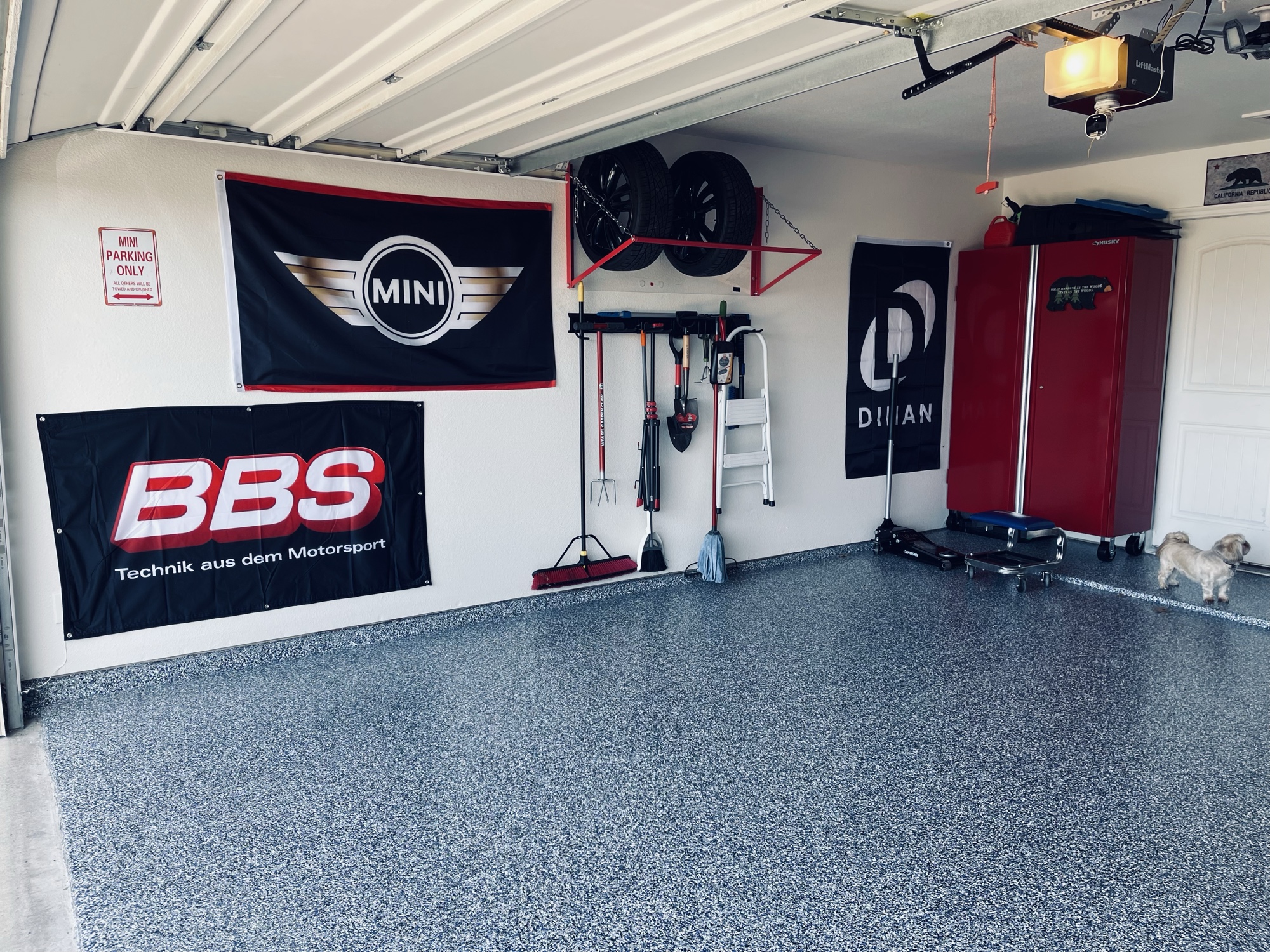 Organized tool chests, Forge Motorsport banner, and detailing equipment